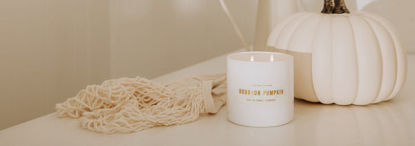 Fall scented soy candle sitting in fall decor