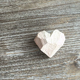 Heart-shaped object on a wooden surface